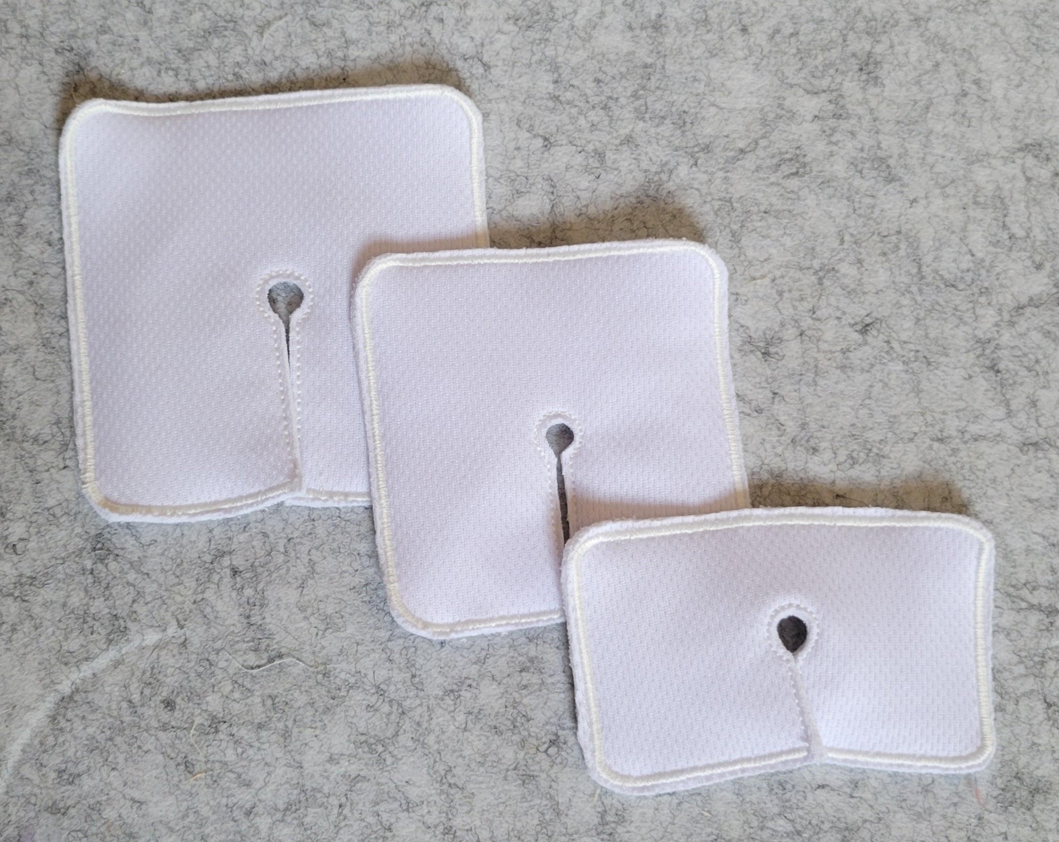 trach pads in white on a grey background