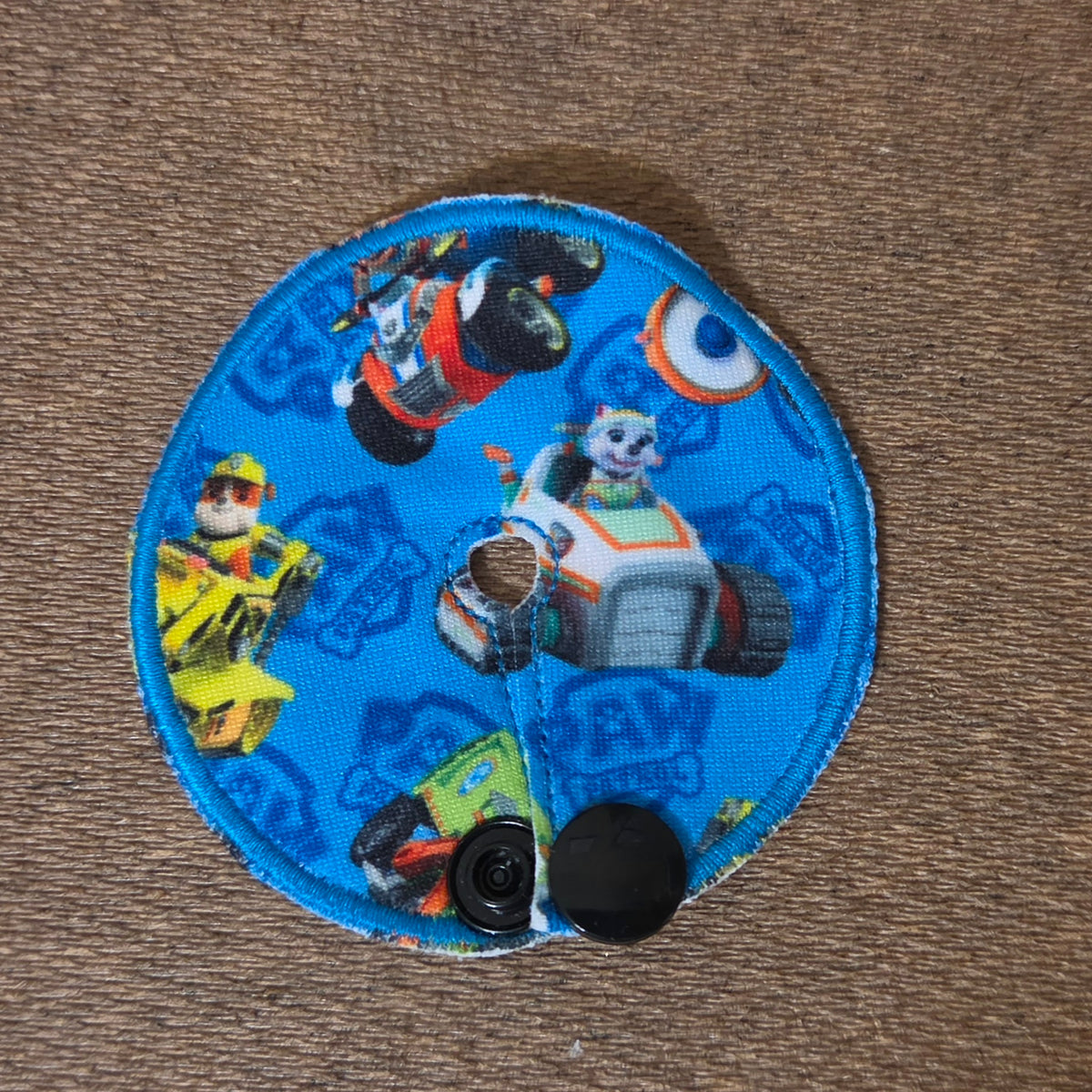 Mini gtube pad blue background with various pup characters and their vehicles
