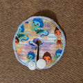 Mini gtube pad in sea monster boy print on striped blue and purple watercolor bled background