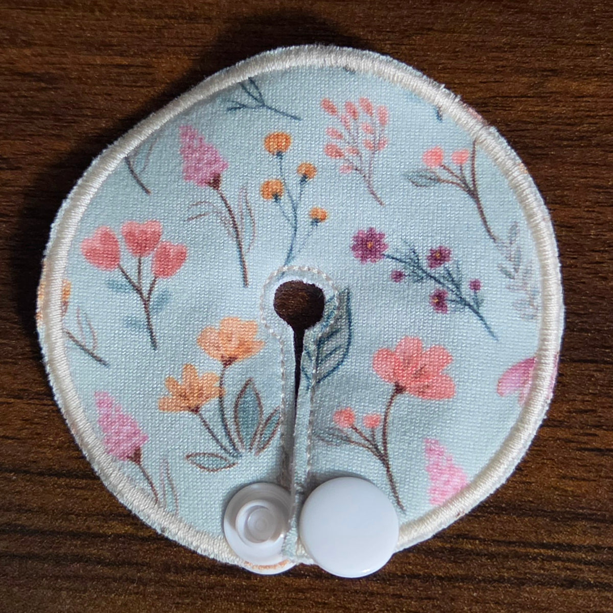 mini gtube pad in floral print with light teal background