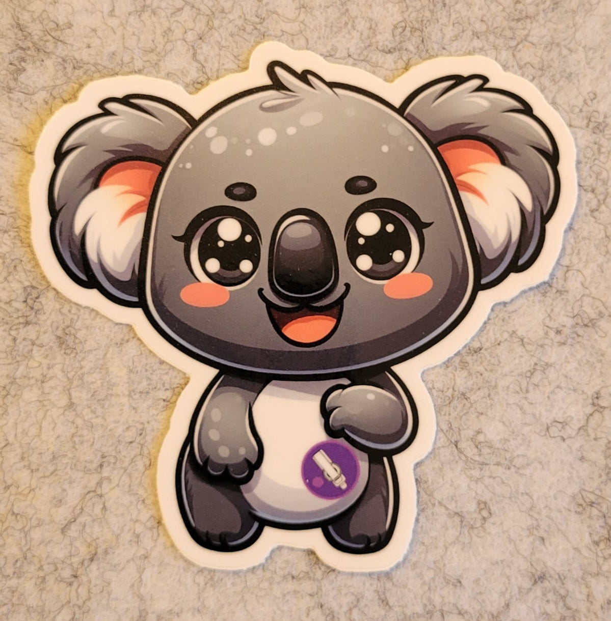 Cartoon koala sticker on a textured beige background
