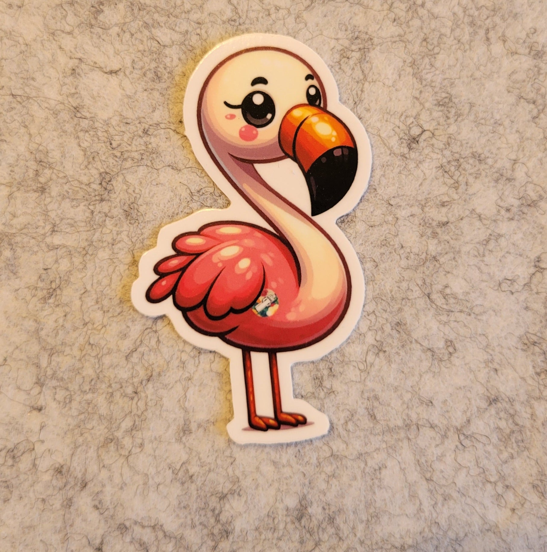 Cartoon flamingo sticker on a textured beige background