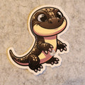 Cartoon salamander sticker on a textured surface