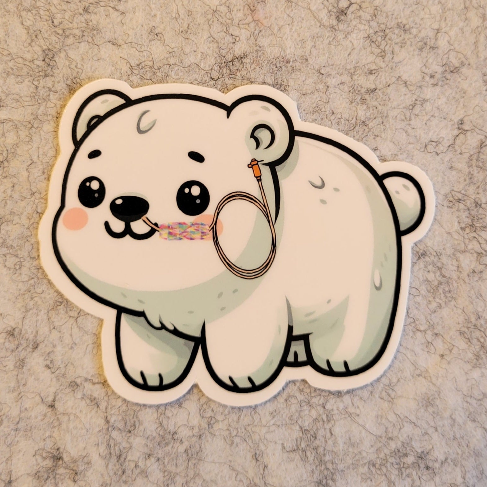 Cartoon polar bear sticker featuring an NG tube in use on a textured surface