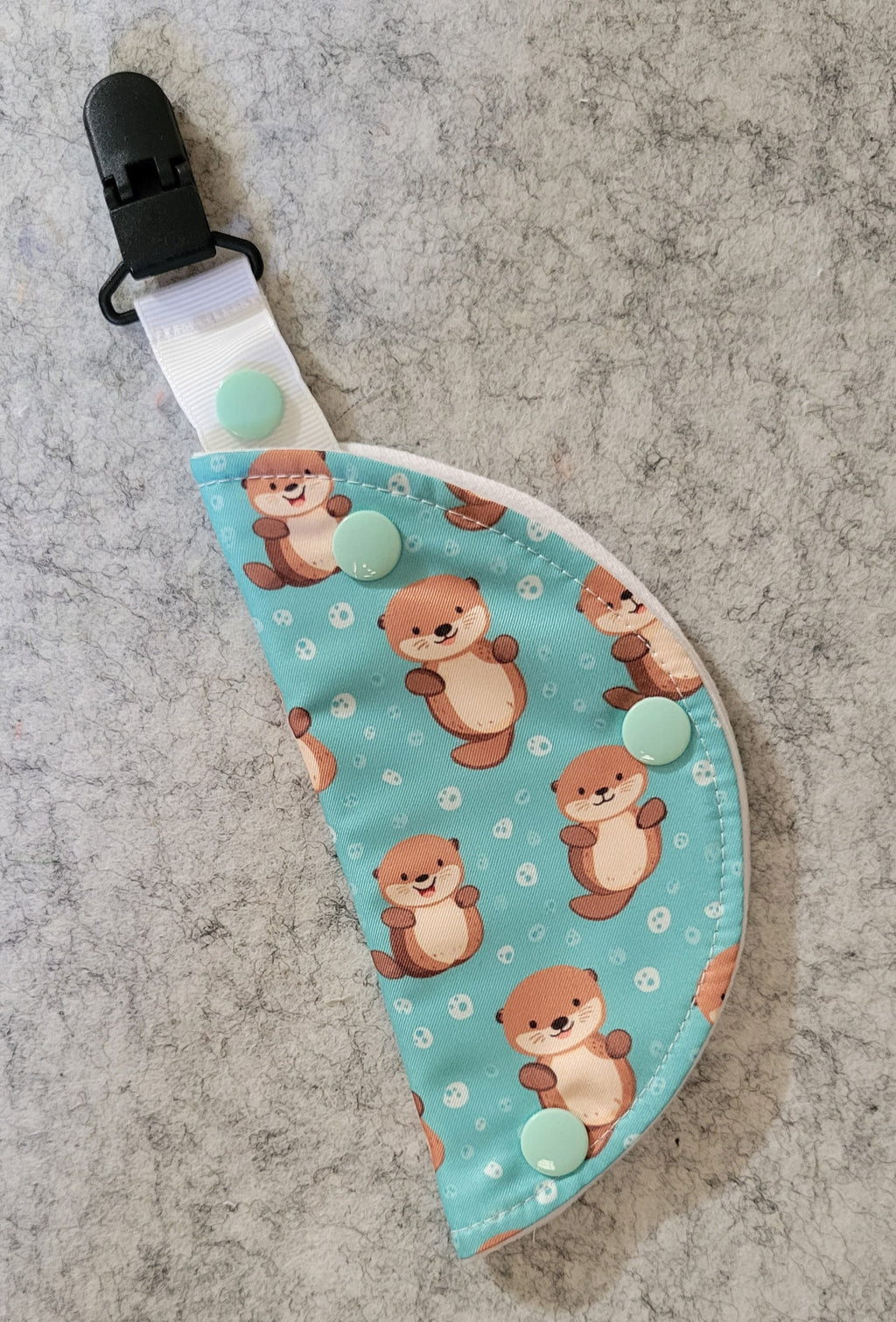 Clip on port cover in otter print on teal water background