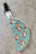 Clip on port cover in otter print on teal water background