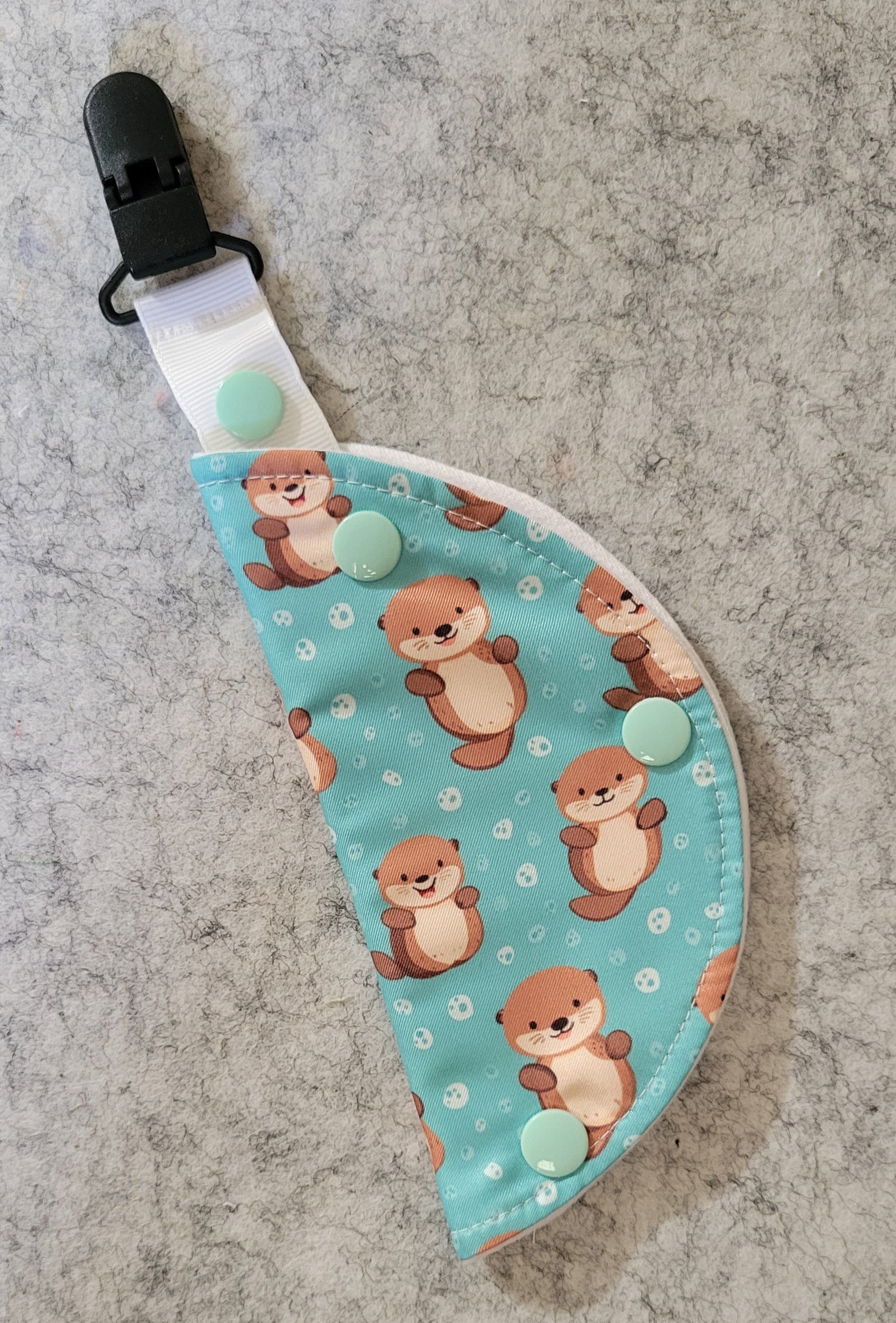 Clip on port cover in otter print on teal water background