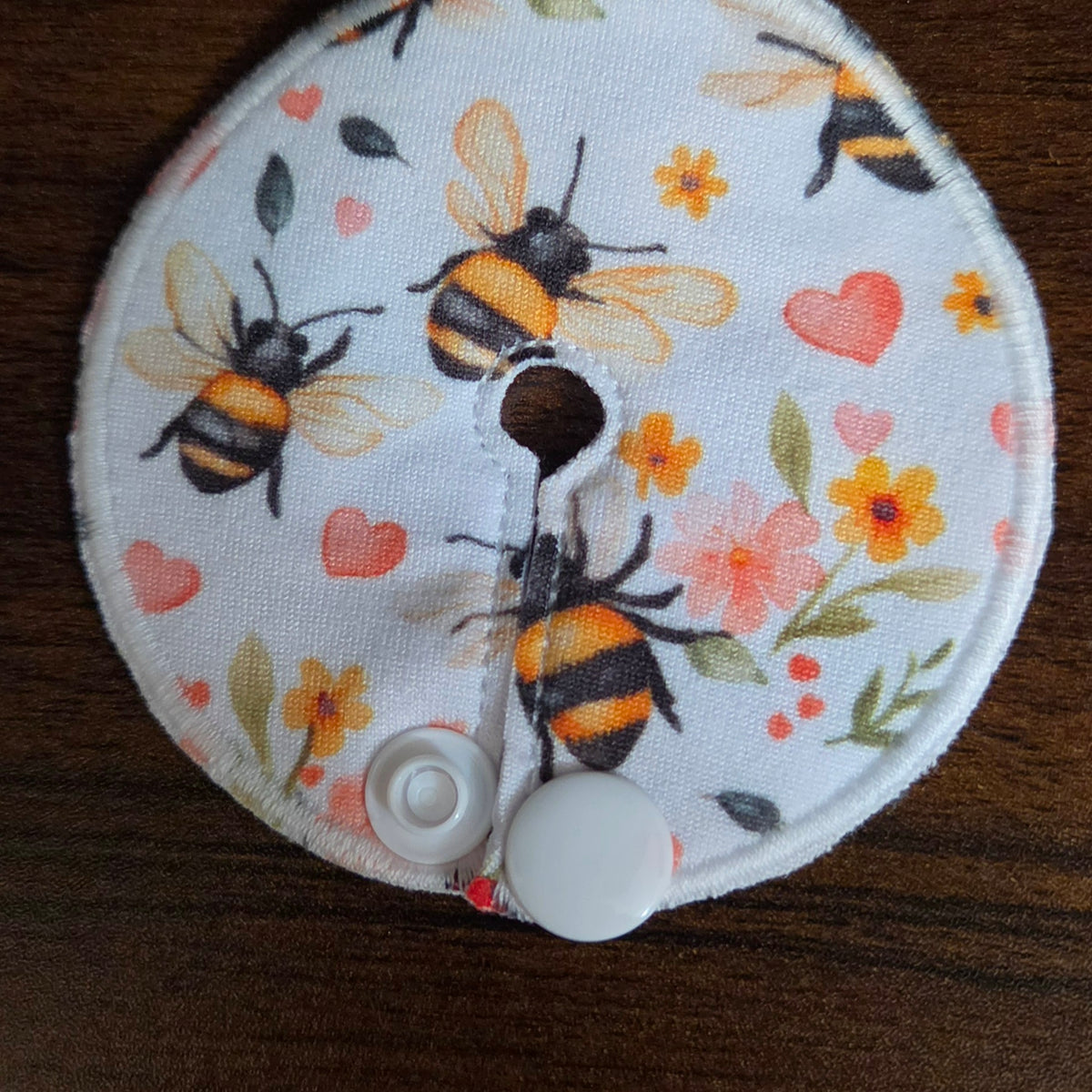 Gtube pad with bees and flowers with pink hearts on white background