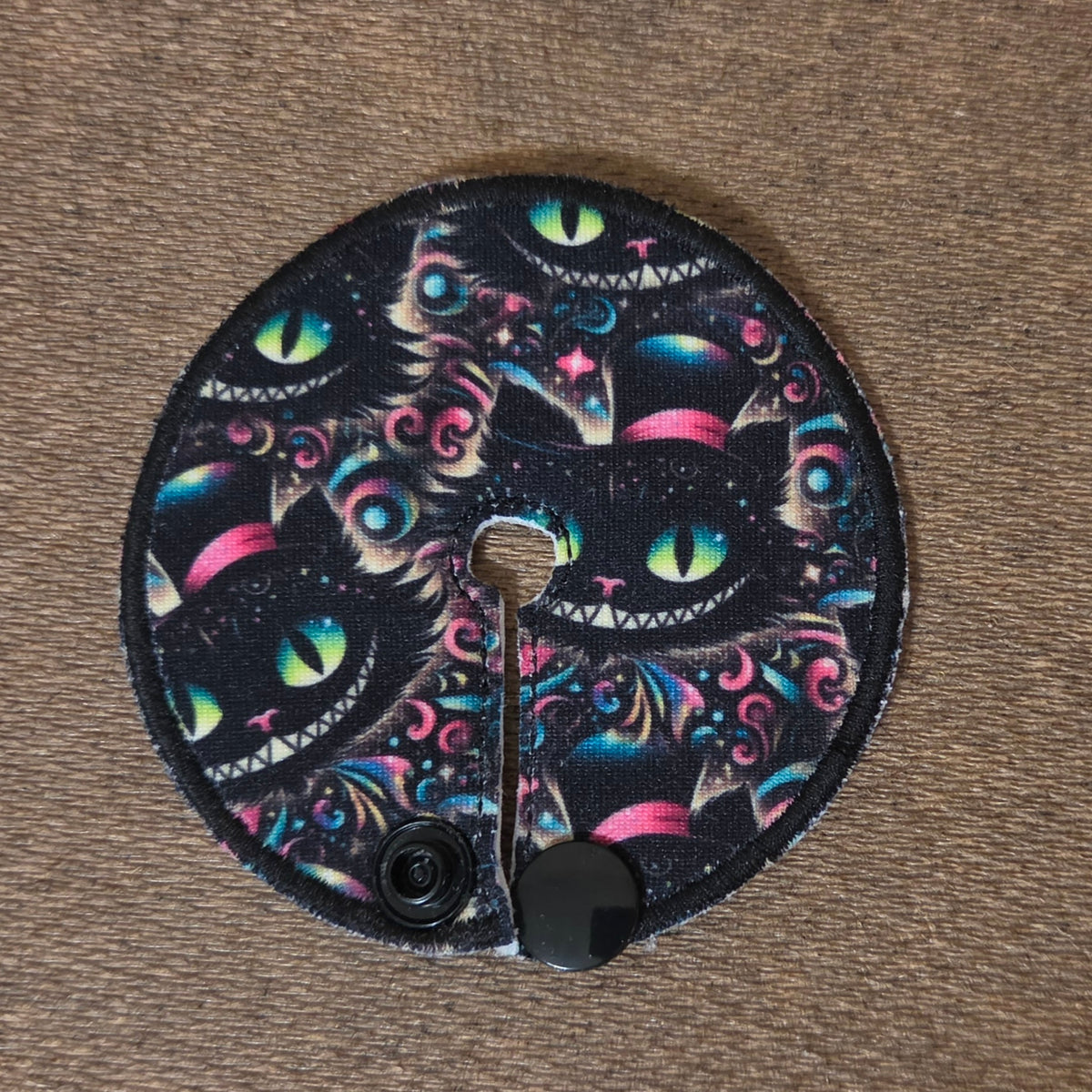 Gtube pad with cheshire cat character with neon yellow and blue on a black background