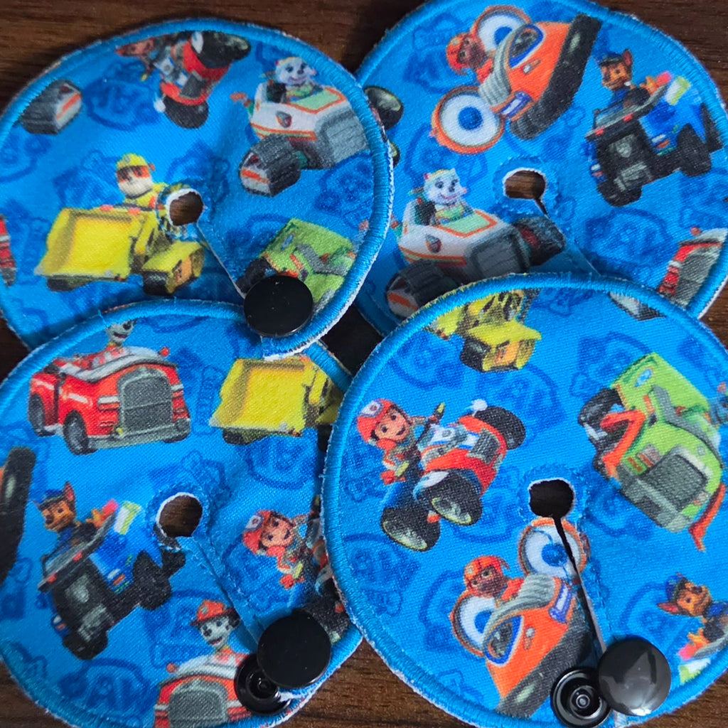 Collage of 4 gtube pads with pup characters driving rescue vehicles on blue background