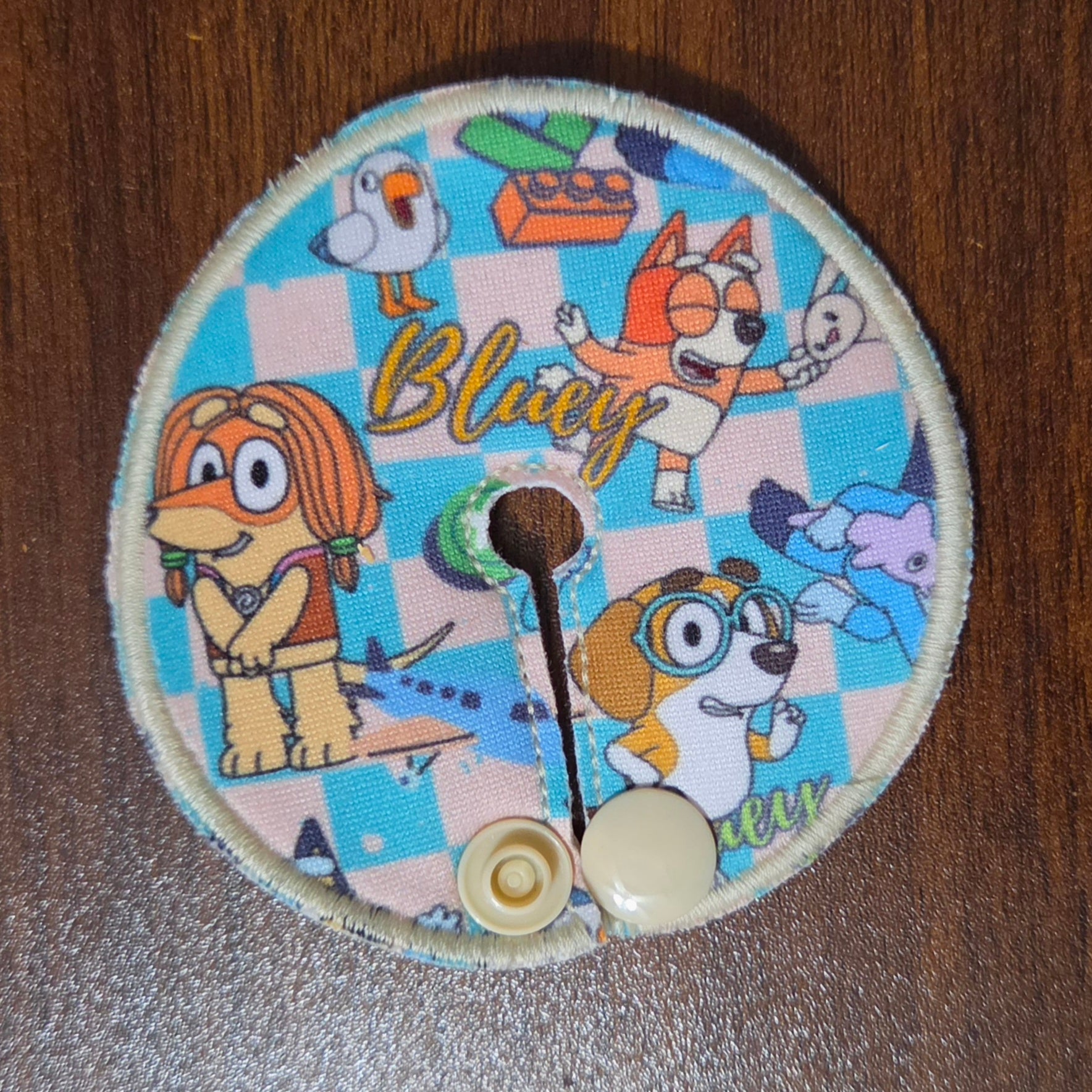gtube pad with blue and tan checkerboard with Aussie dog characters