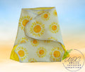 reuseable diaper with sunflower pattern on a gradient background