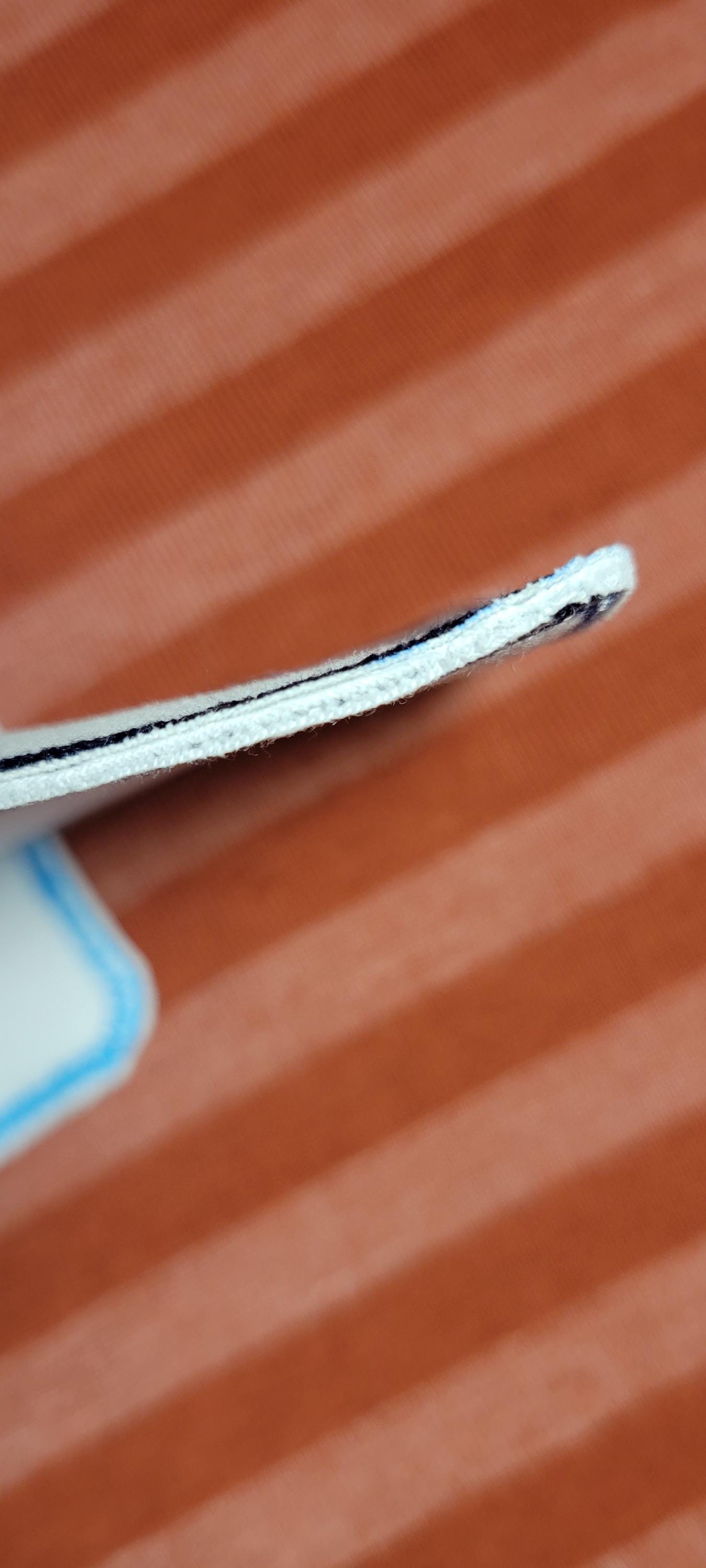 Thickness view on an orange striped background