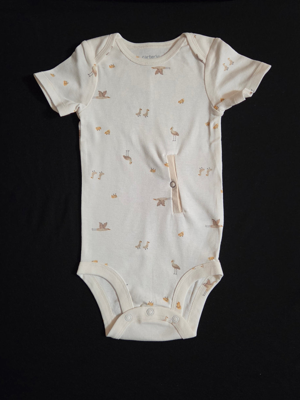 gtube adapted bodysuit with small cranes and chicks on a cream background