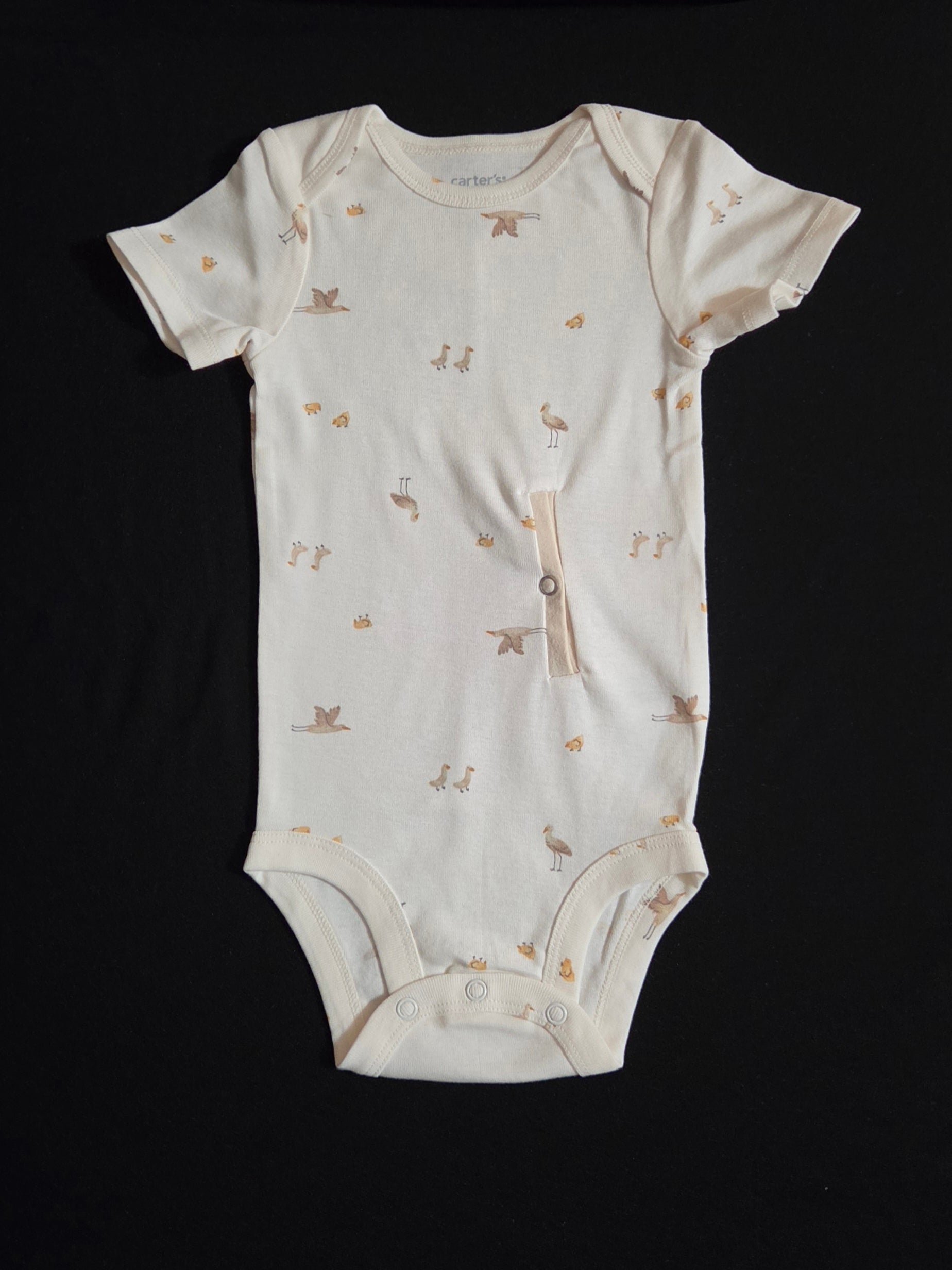 gtube adapted bodysuit with small cranes and chicks on a cream background