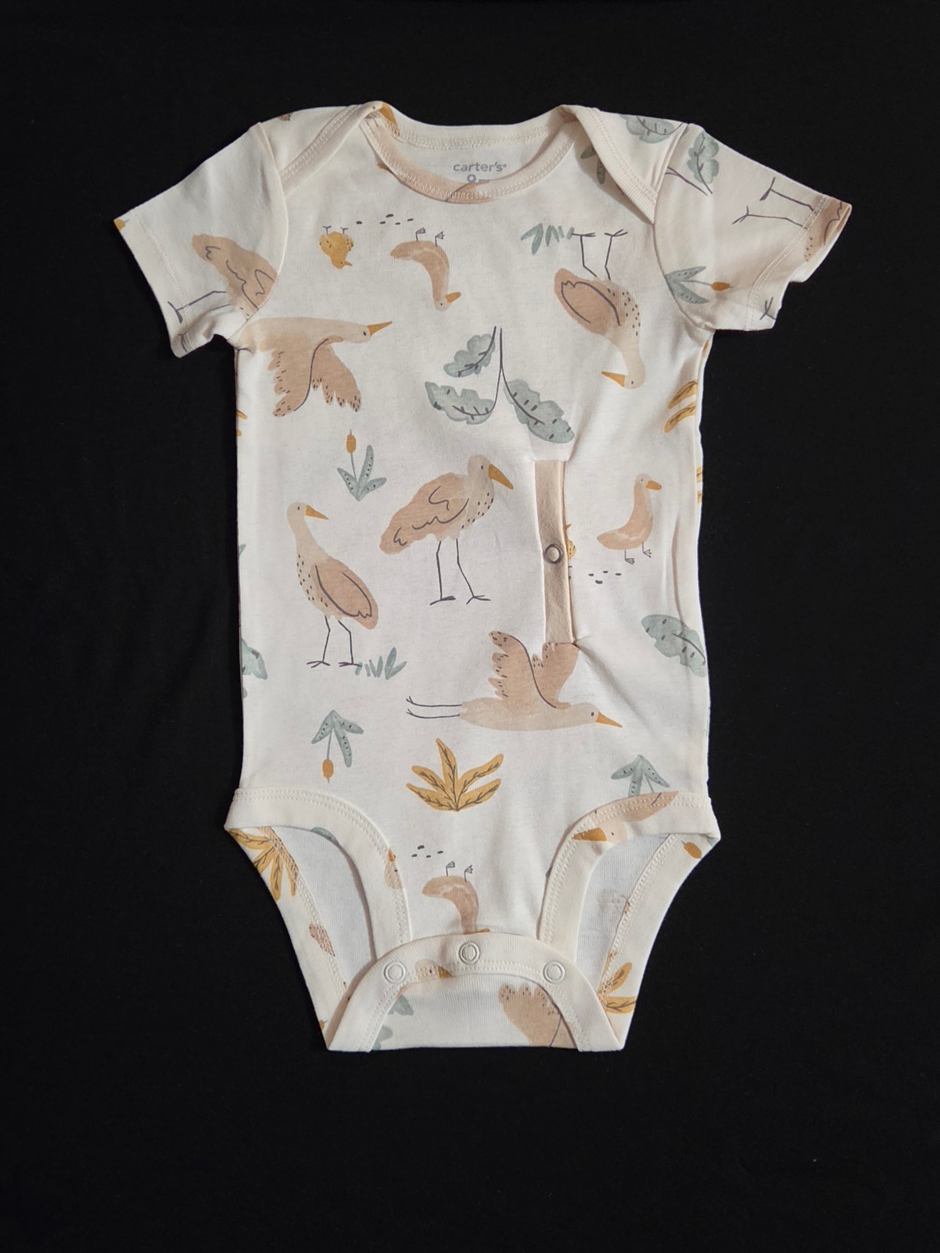 gtube adapted bodysuit with cranes and leaves on a cream background