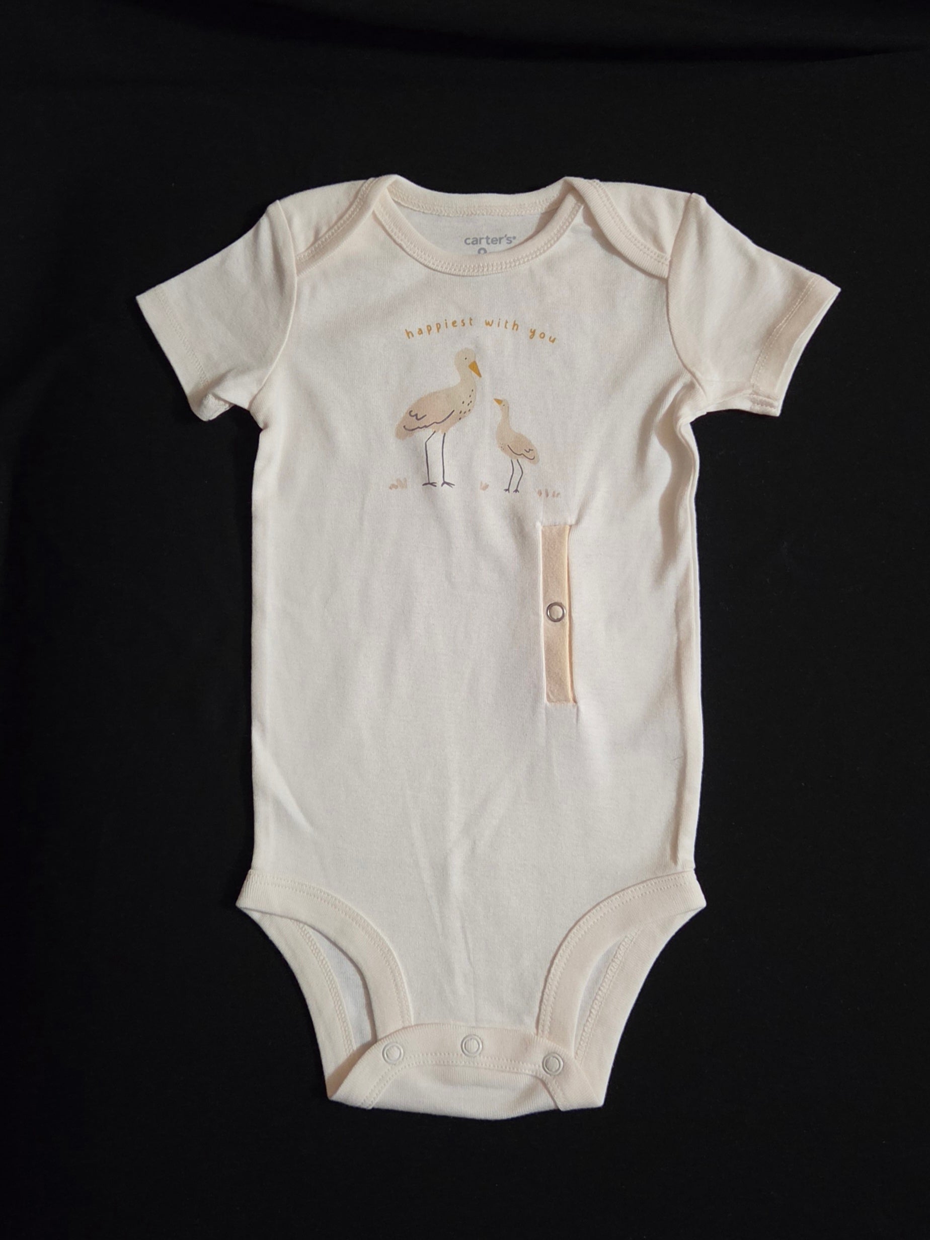 Gtube adapted bodysuit on cream background with Crane and baby wording says happiest with you
