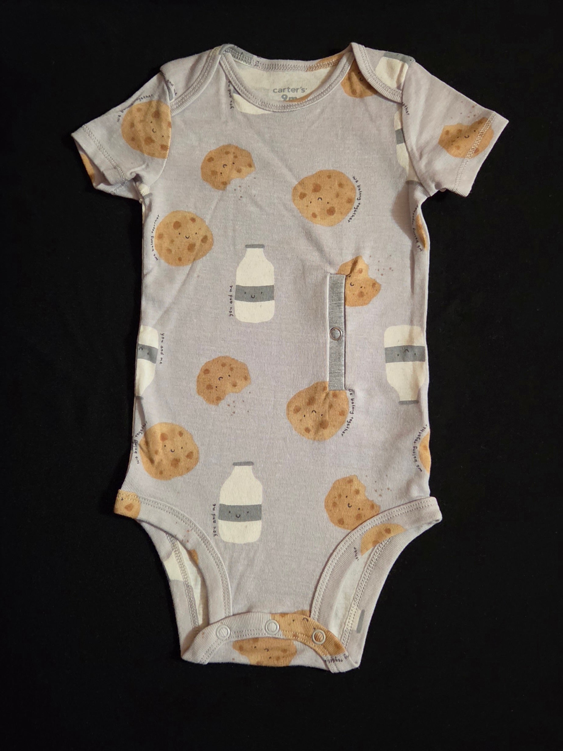 Gtube adapted bodysuit on grey background with milk jugs and cookies