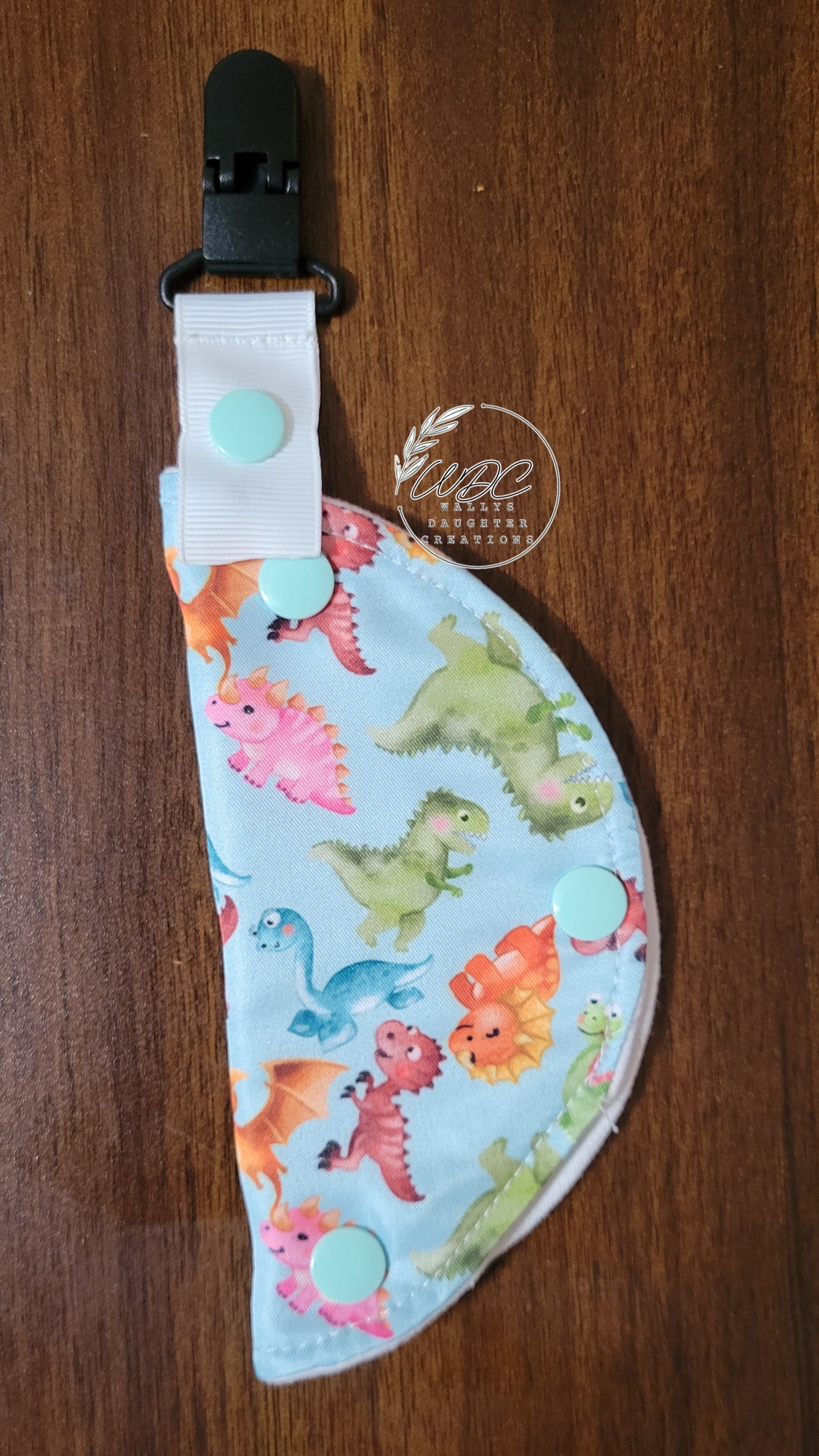 Clip on port cover with baby dinosaur print