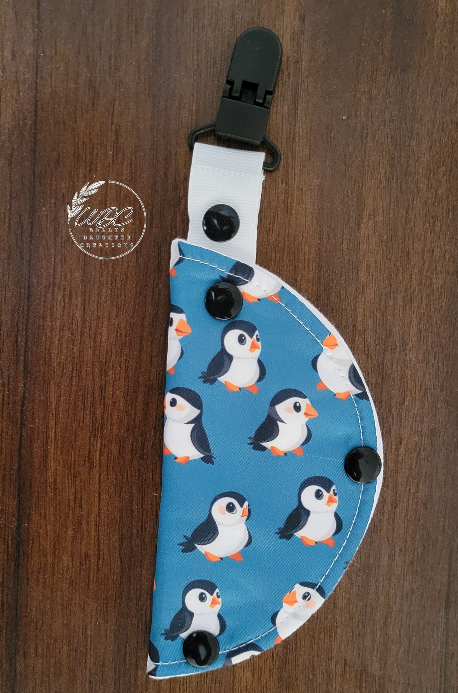 clip on port cover with penguins on dark teal background