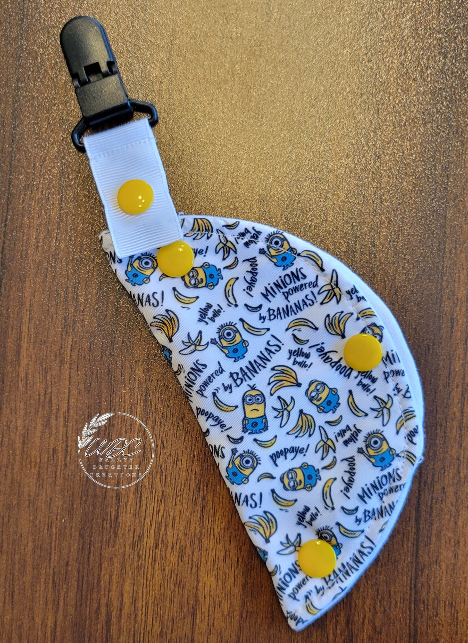 Clip on port cover with little overall wearing yellow characters and bananas with the words minion powered and bananas.