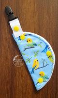 Clip on port cover with parrots on a light blue background