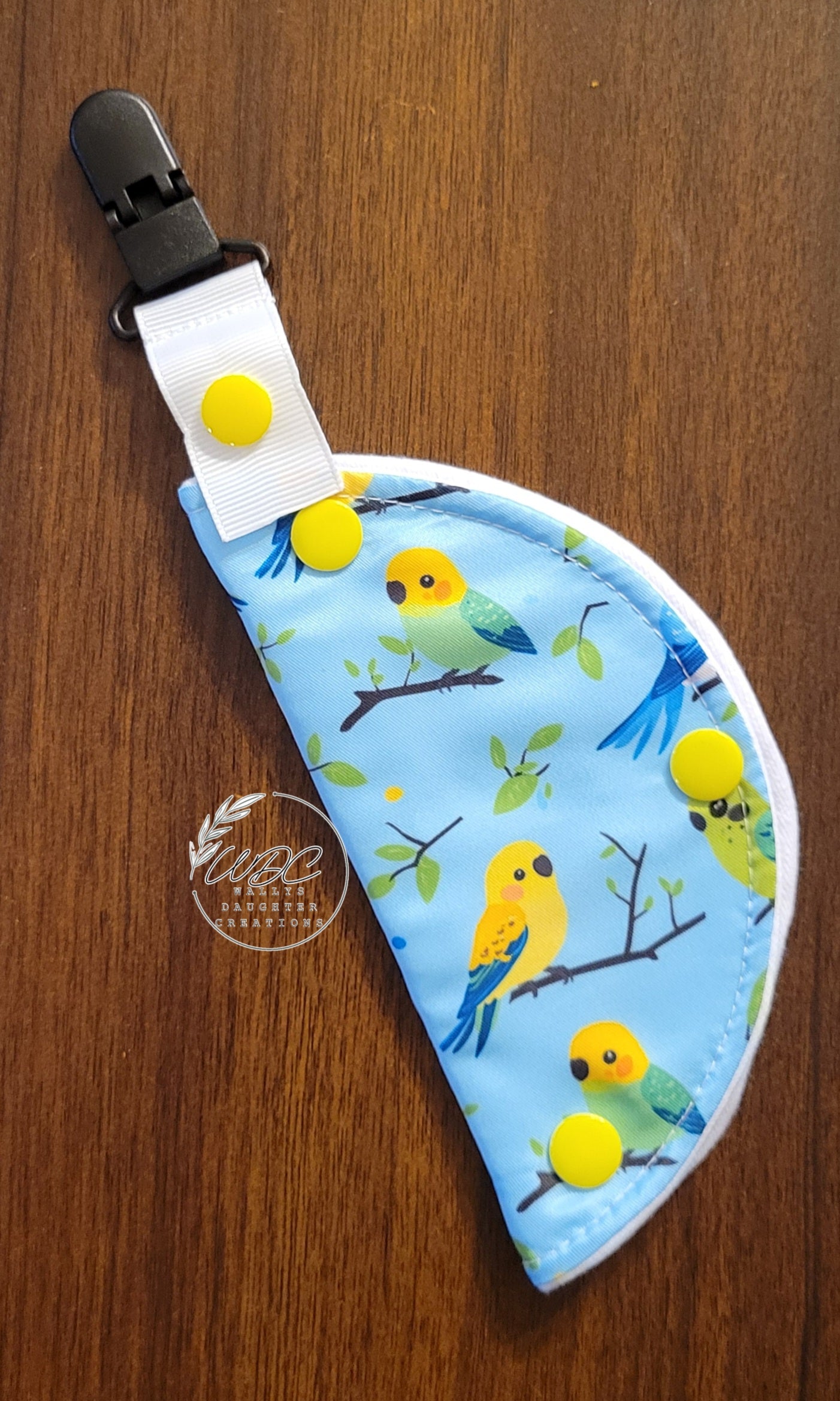 Clip on port cover with parrots on a light blue background