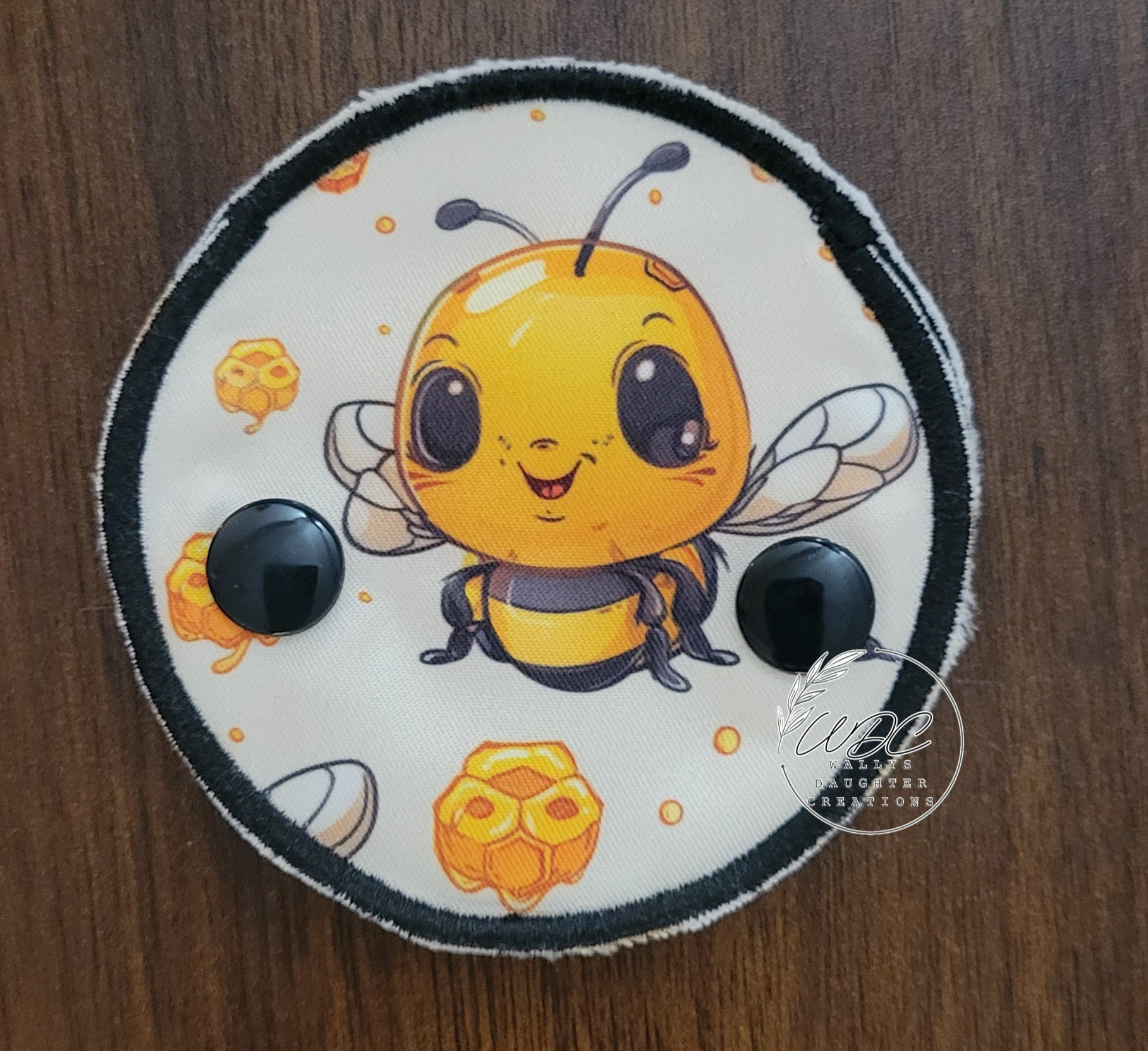 Snap down covered pad with baby bee