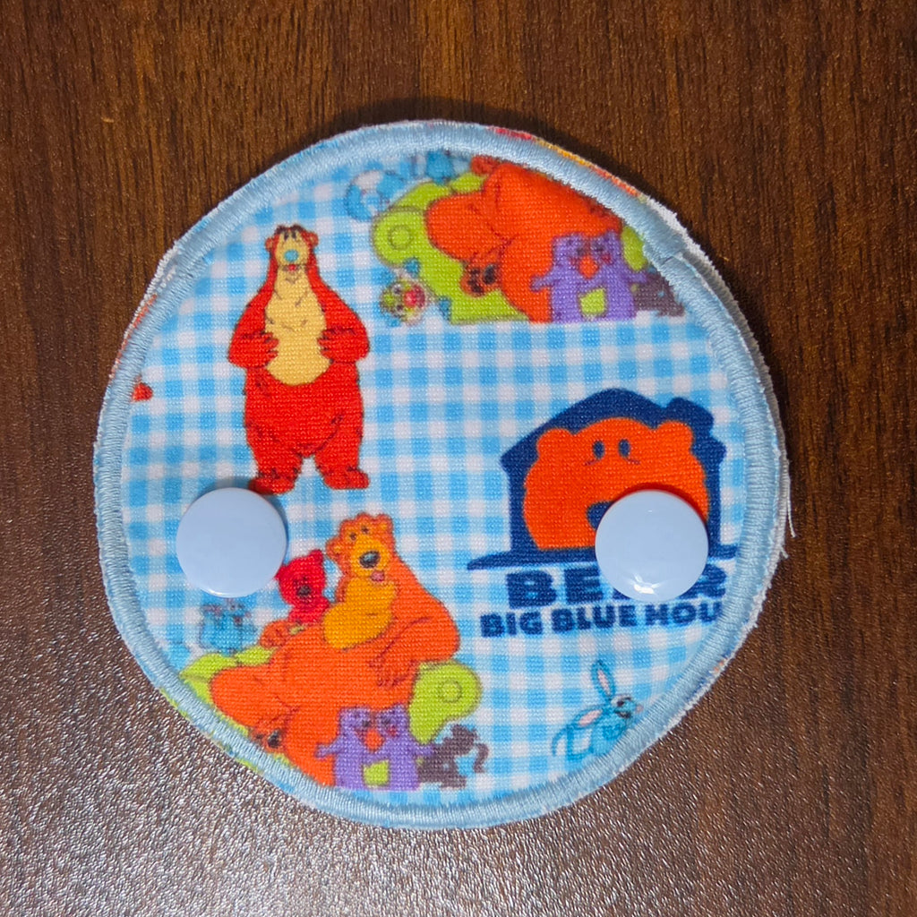snap down gtube pad with big bear character and blue house