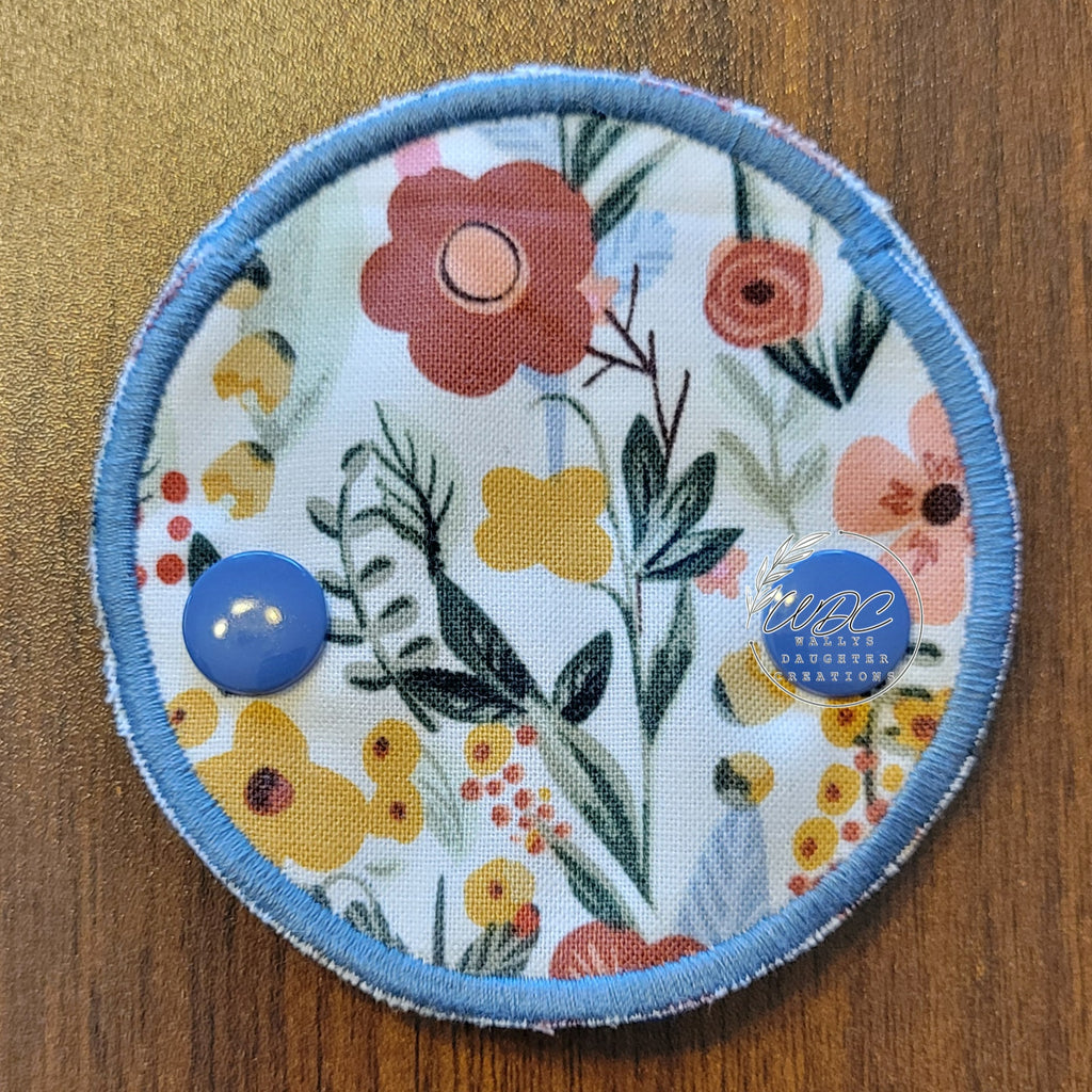Snap down covered gtube pad with a muted boho floral theme