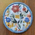 Snap down covered gtube pad with a muted boho floral theme