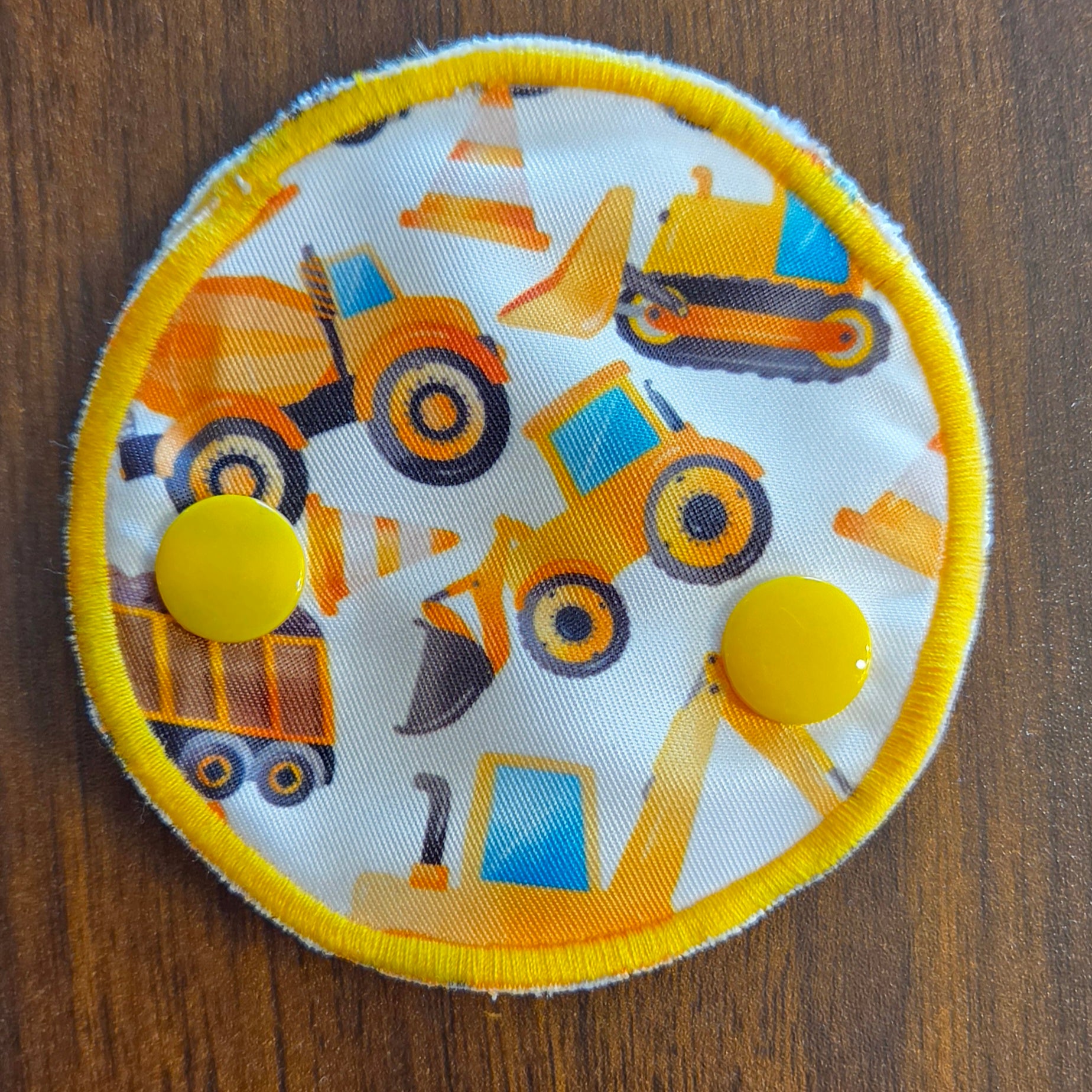 Snap down covered gtube pad with construction equipment print
