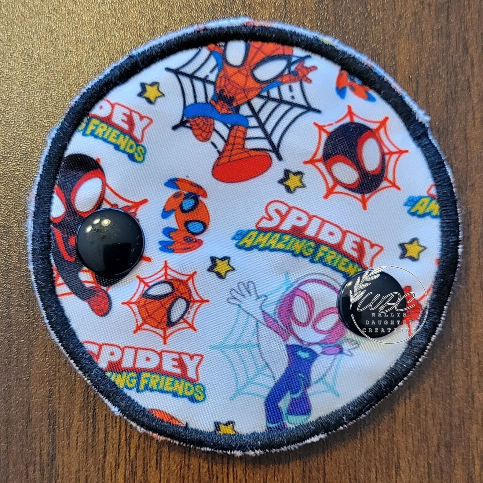 Snap down covered pad with spider characters and webs