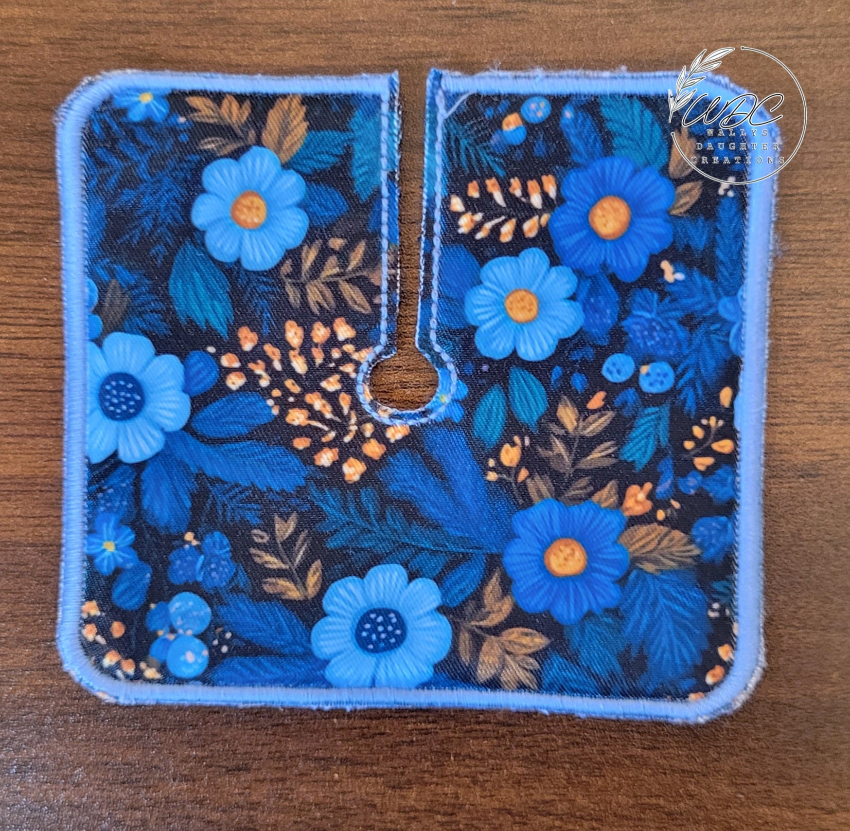 Trach pad with blue floral print and gold small floral sprays on black background