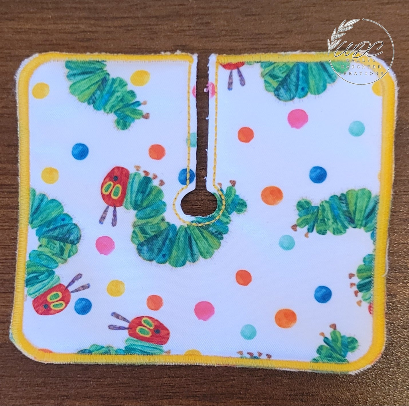 Trach Pad in caterpillar print with multicolor polka dot on white background
