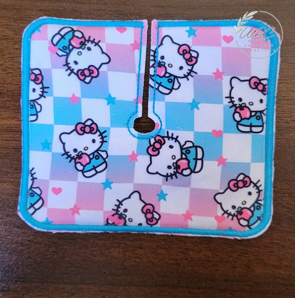 Trach pad with ombre checker background showing kitty character