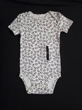 gtube adapted bodysuit with black leaves on a cream background 