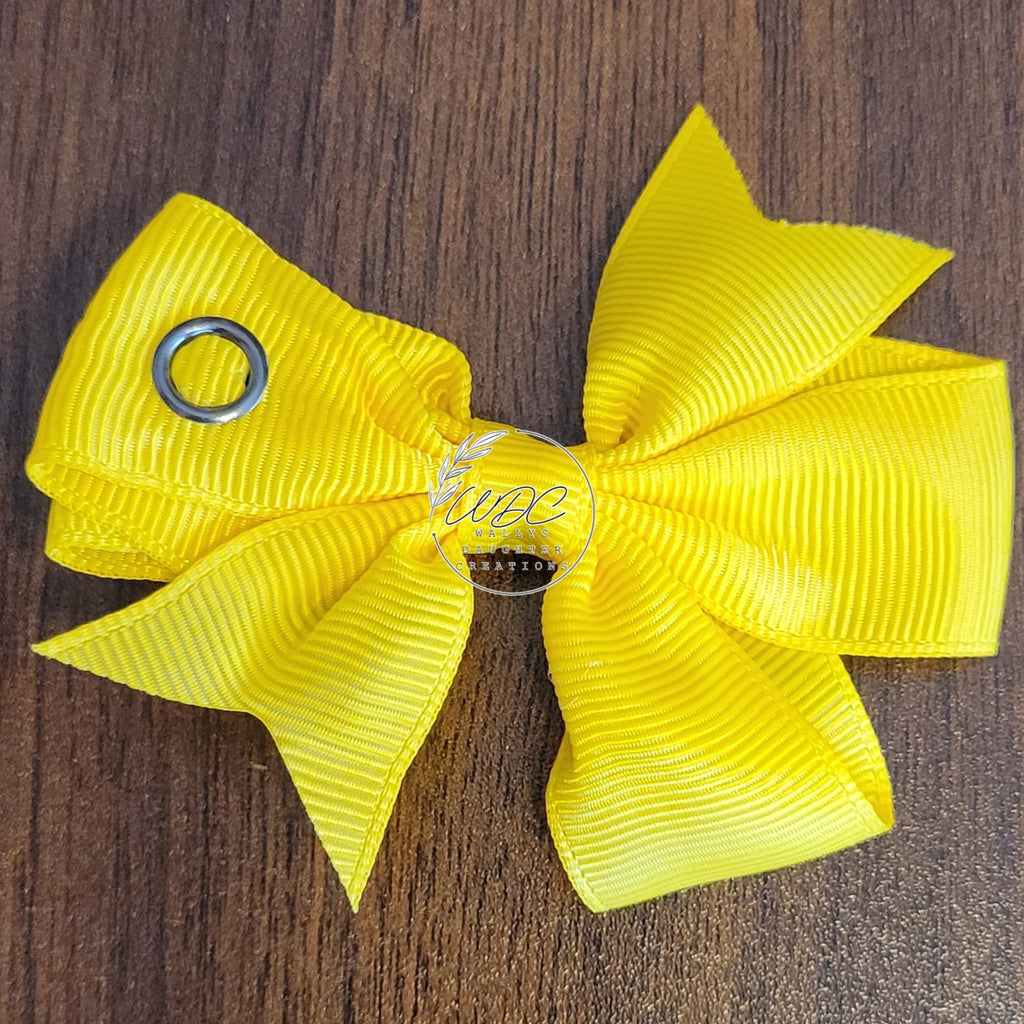 Yellow hair bow with snap showing snapped closed