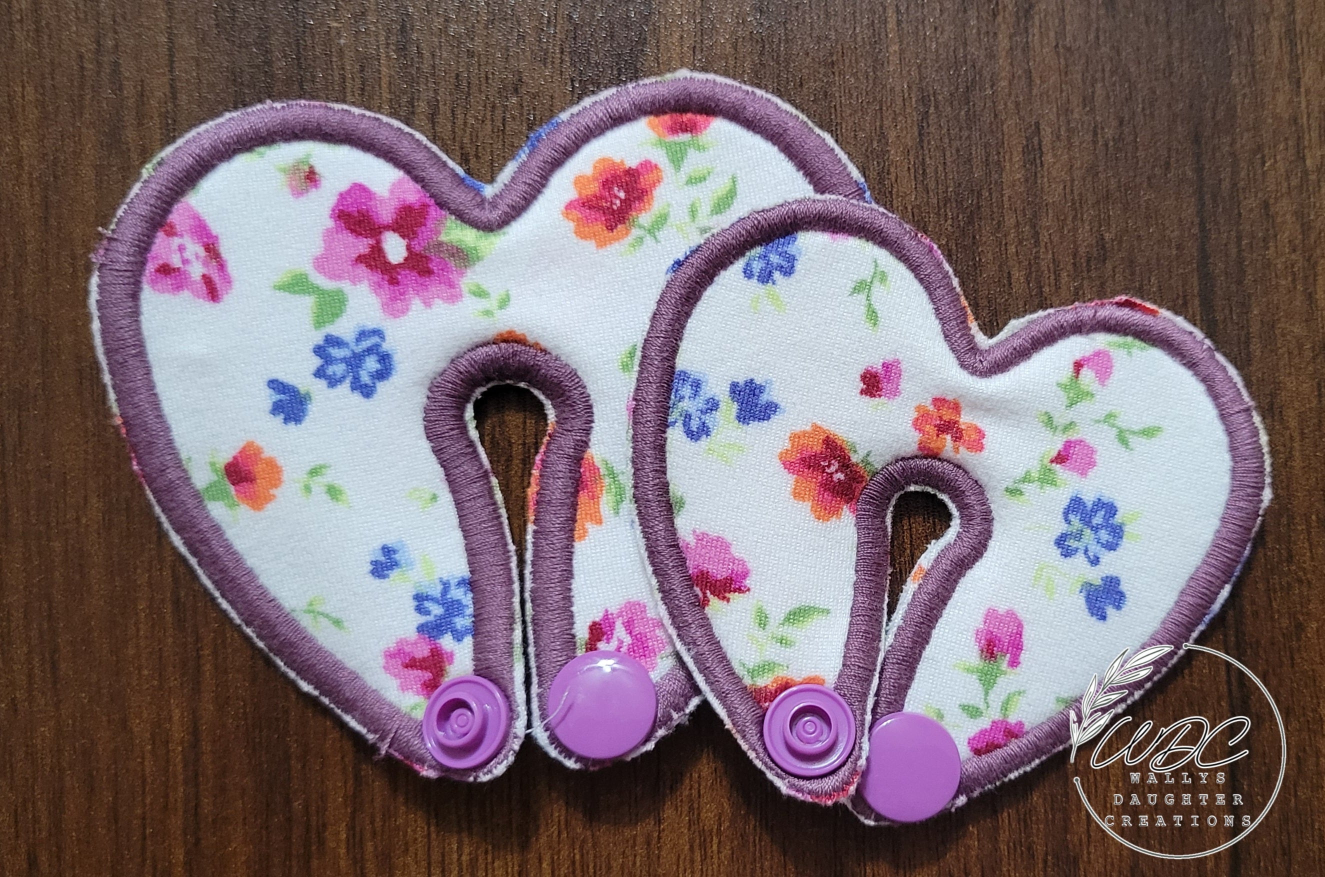 Heart shaped gtube pad with floral fabric and purple thread in 2 sizes