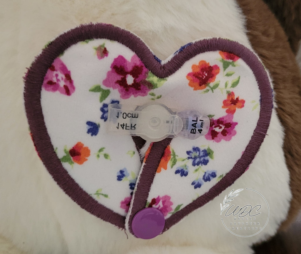 heart shaped gtube pad around a mini button on a stuffie