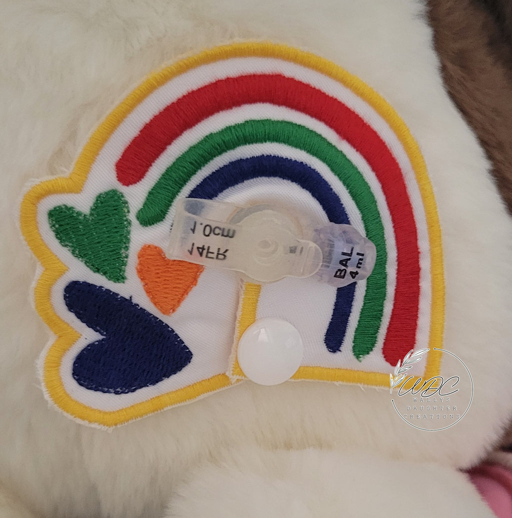Primary Colored gtube pad around a mini tube button on a stuffie