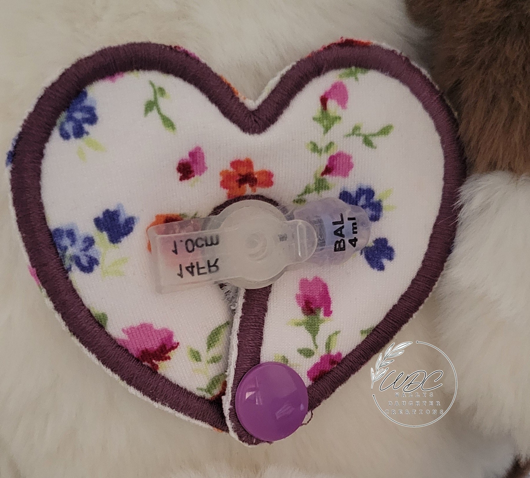 heart shaped gtube pad on a mini button on a stuffie