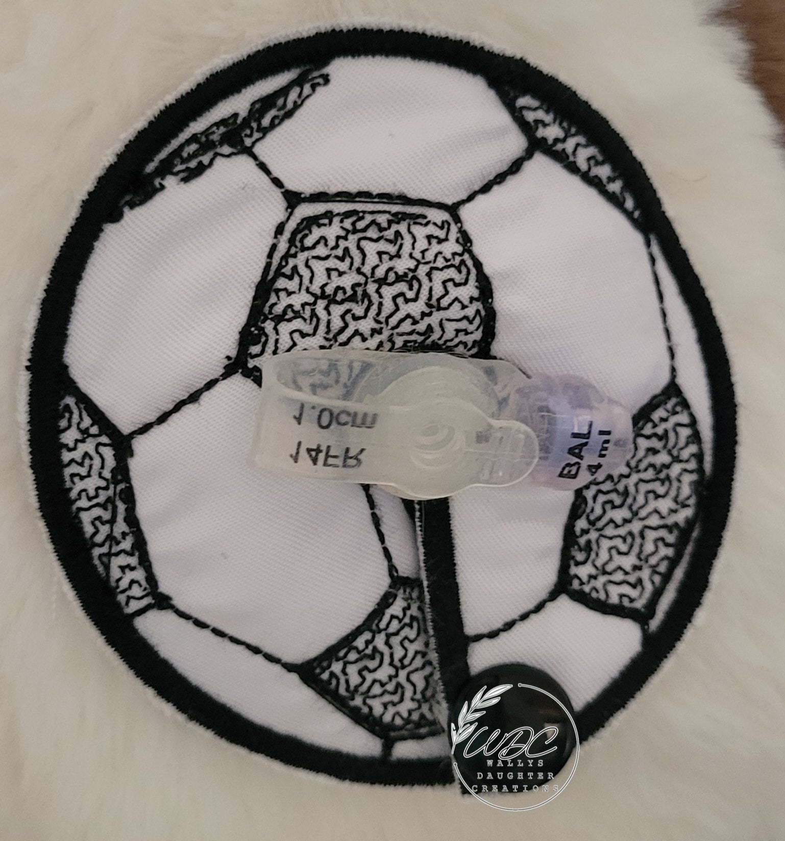 Soccer ball embroidered gtube pad around a feeding tube button