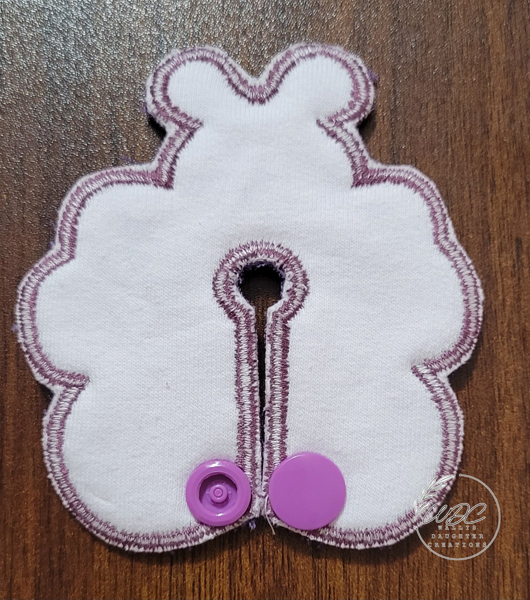 backing view of butterfly shaped gtube pad