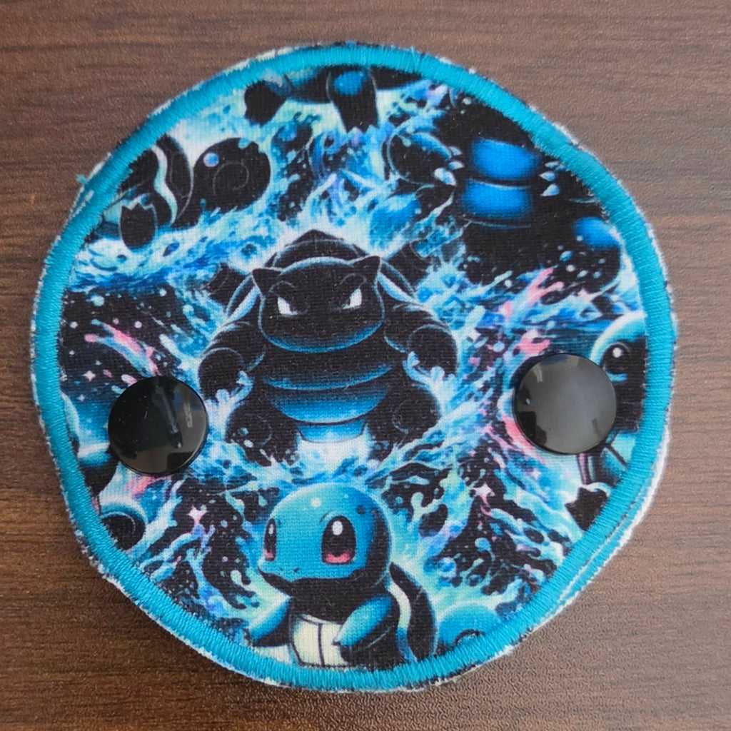 Blue Squirt character in snap down gtube pad
