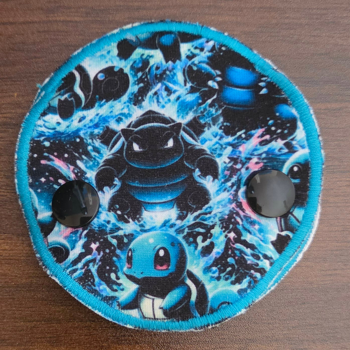 Blue Squirt character in snap down gtube pad