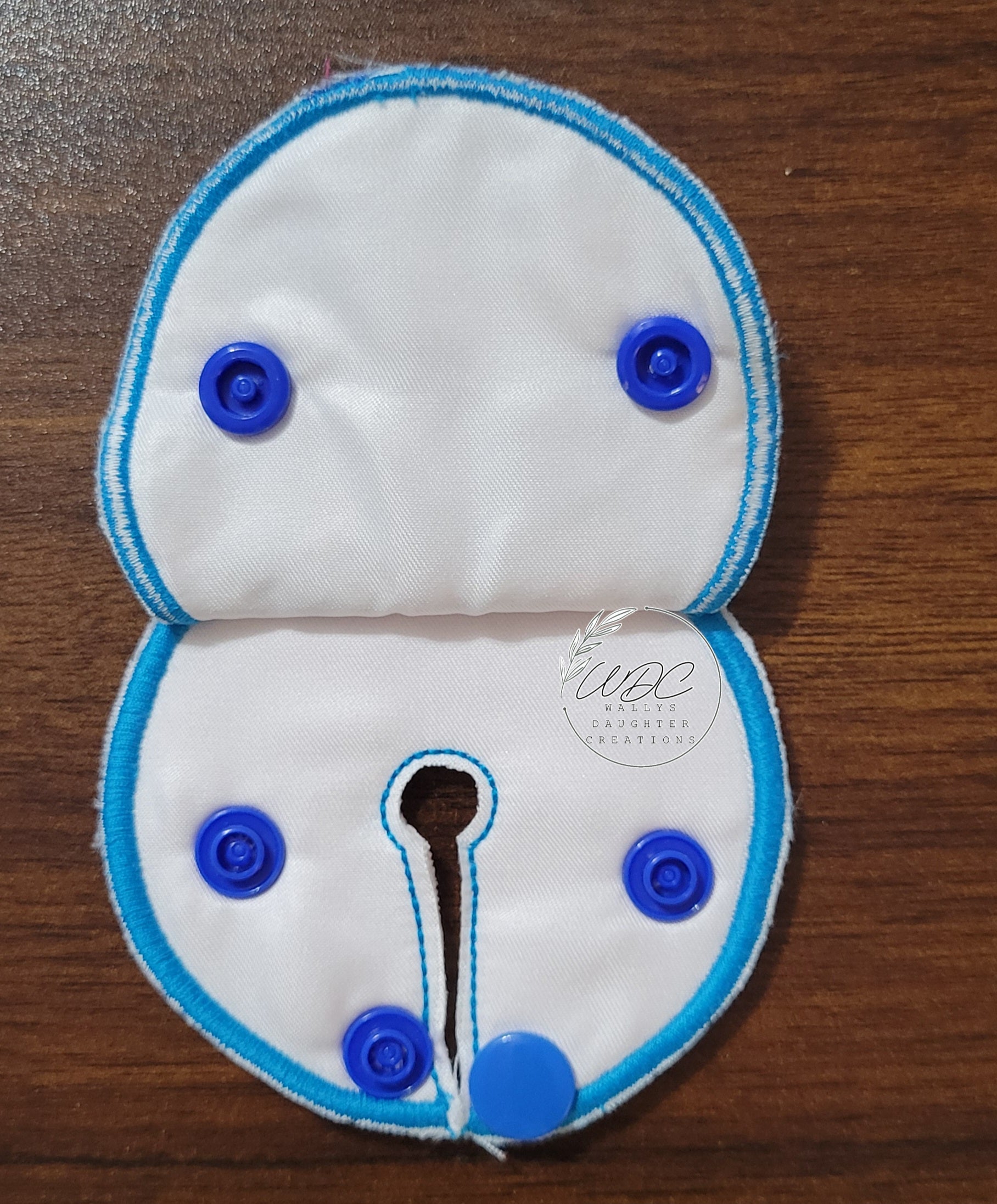 inside view of snap down pad with blue teal thread