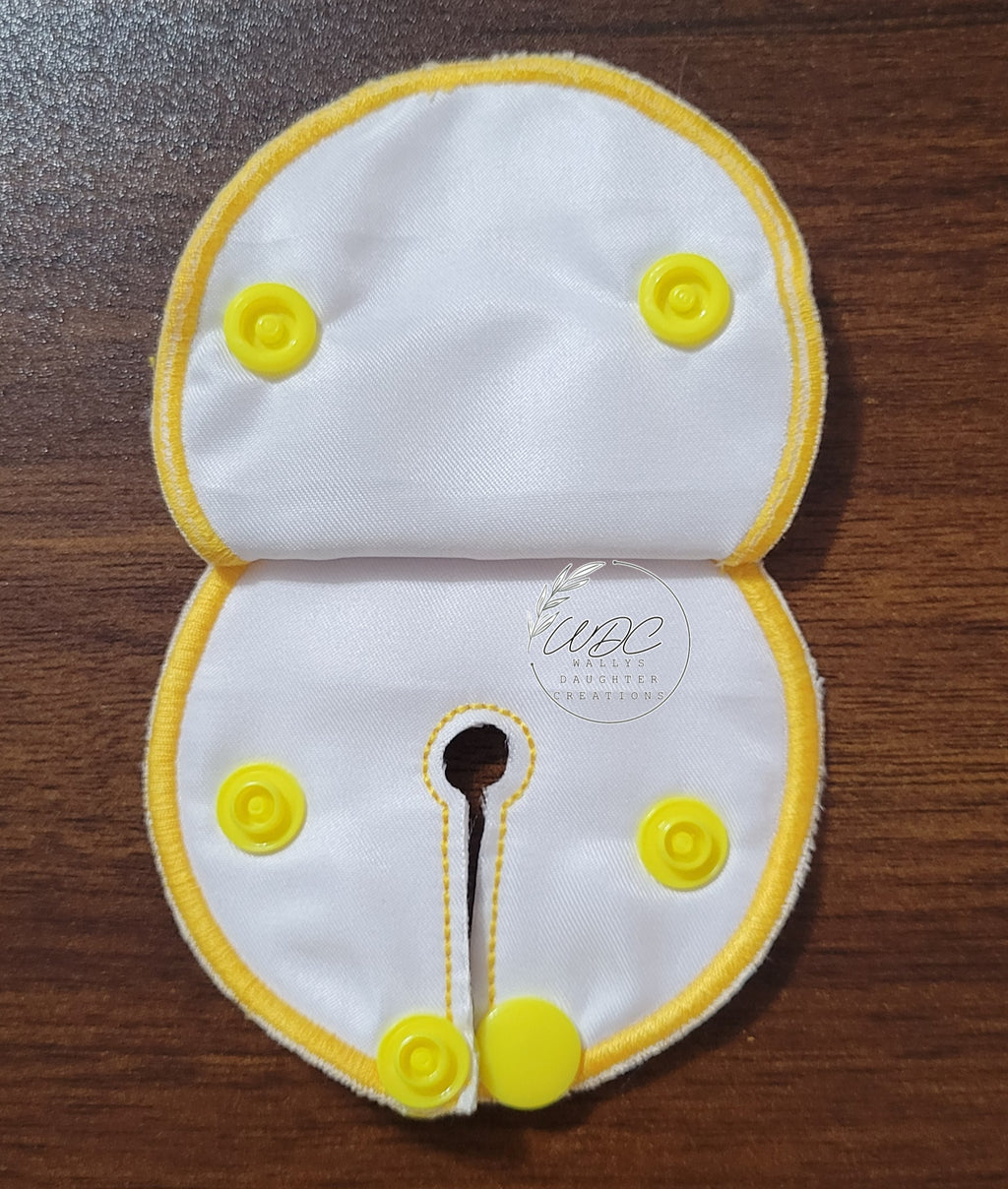 snap down covered pad inside view with yellow thread and snaps