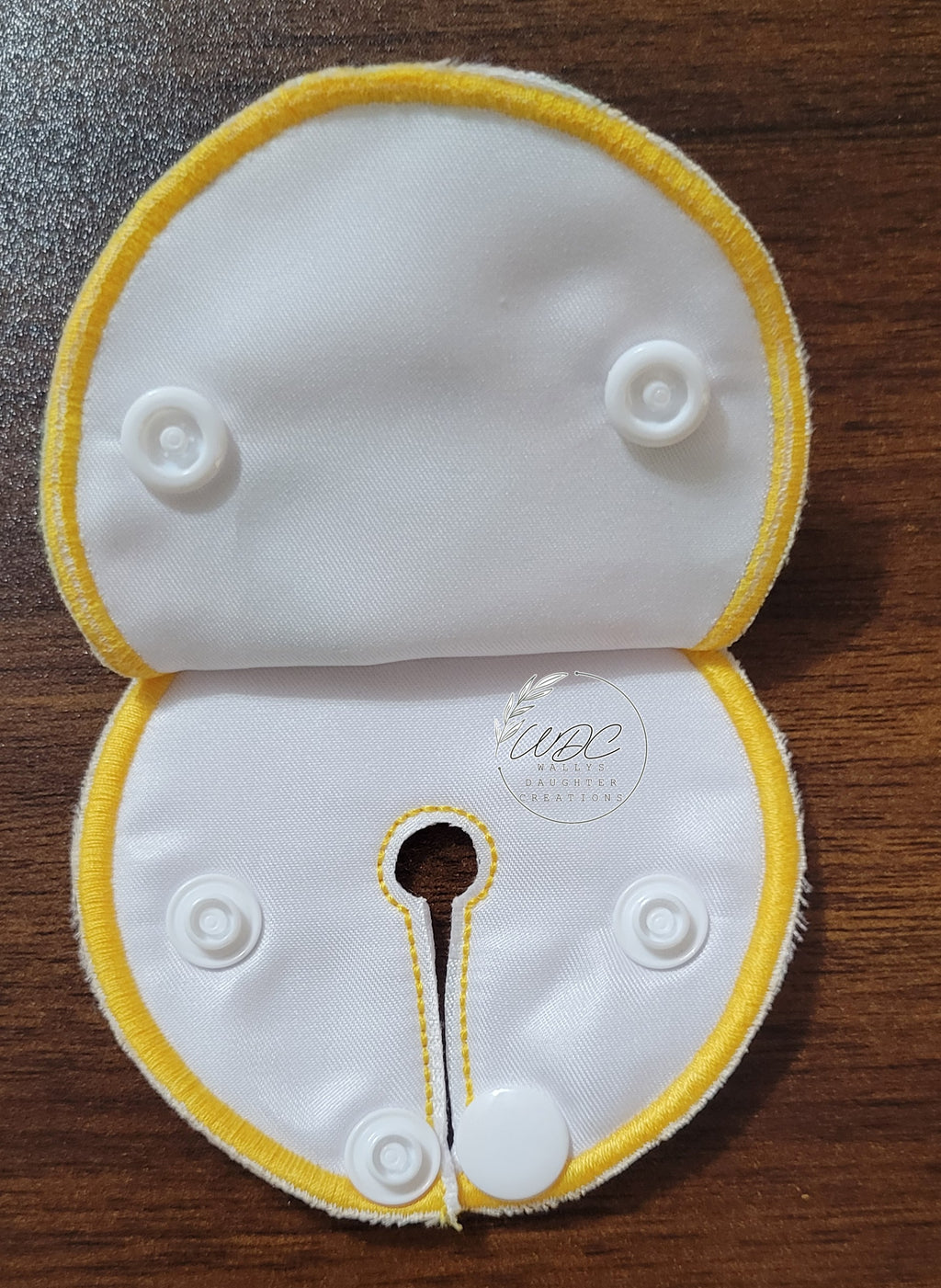 snap down pad inside view with yellow thread and white snaps
